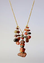 Gold necklace with red pebbles