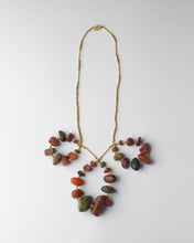 Gold necklace with red pebbles