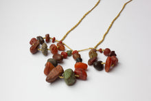 Gold necklace with red pebbles